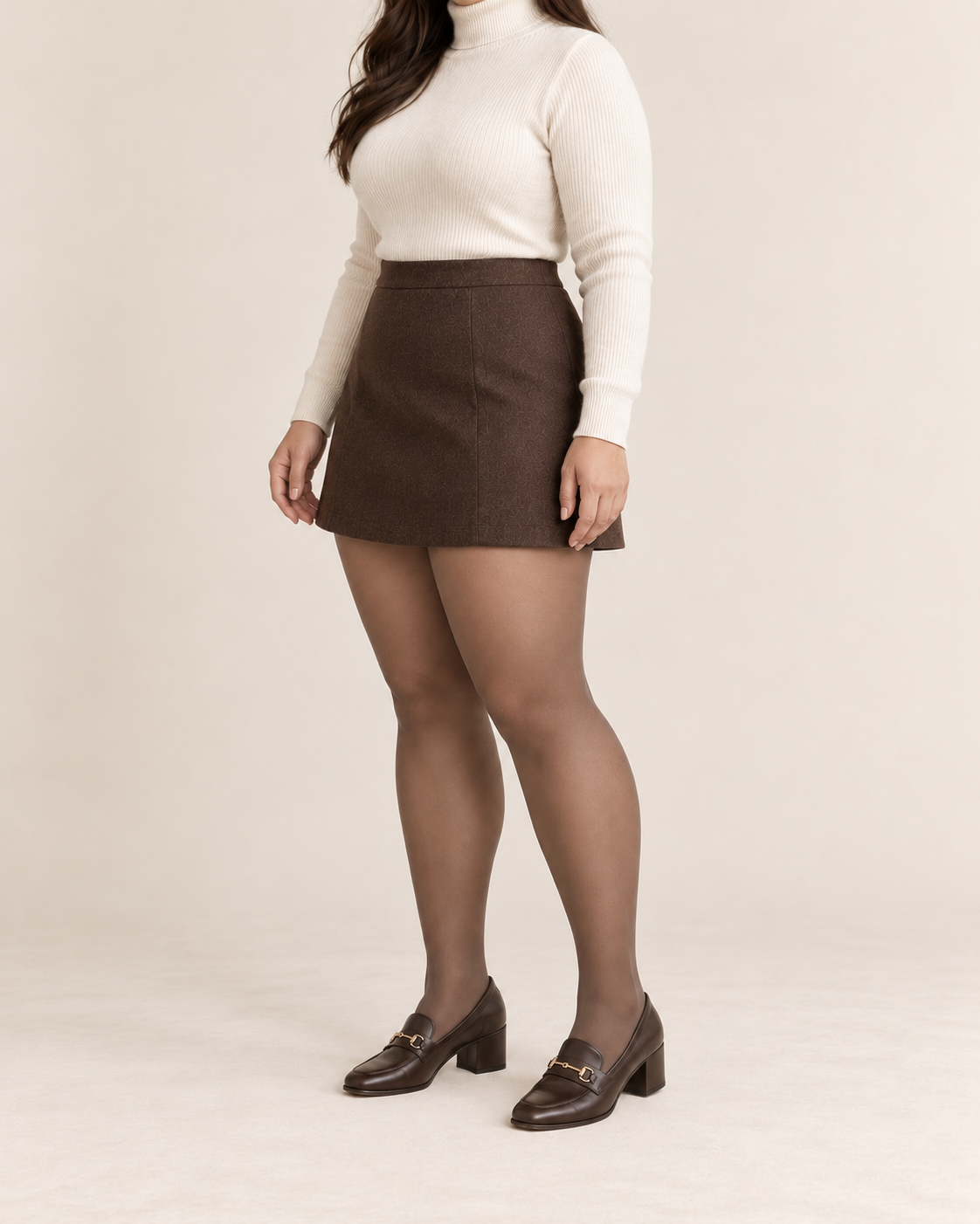Coffee tights on a fuller-figure adult model in an ivory sweater and skirt, three-quarter studio view; Plus styling illustration