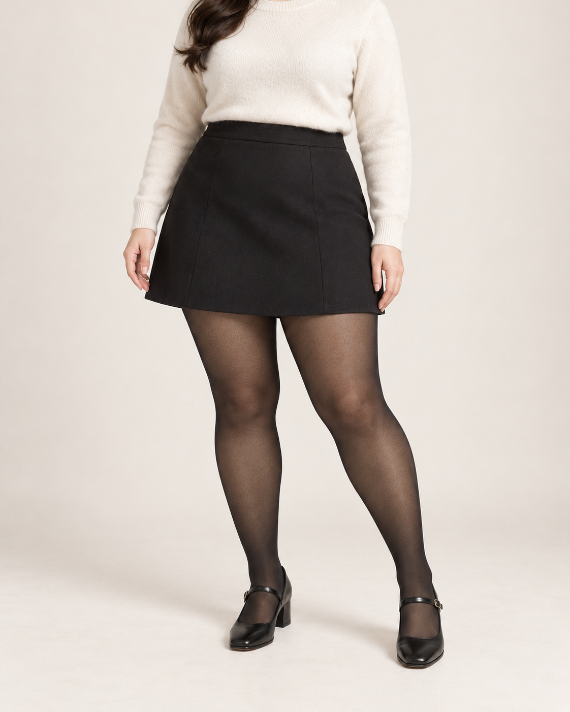 Midnight tights on a fuller-figure adult model in an ivory sweater and skirt, front studio view; Plus styling illustration