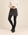 Onyx opaque black tights with a charcoal skirt, ivory sweater and black loafers; shoulders-down view