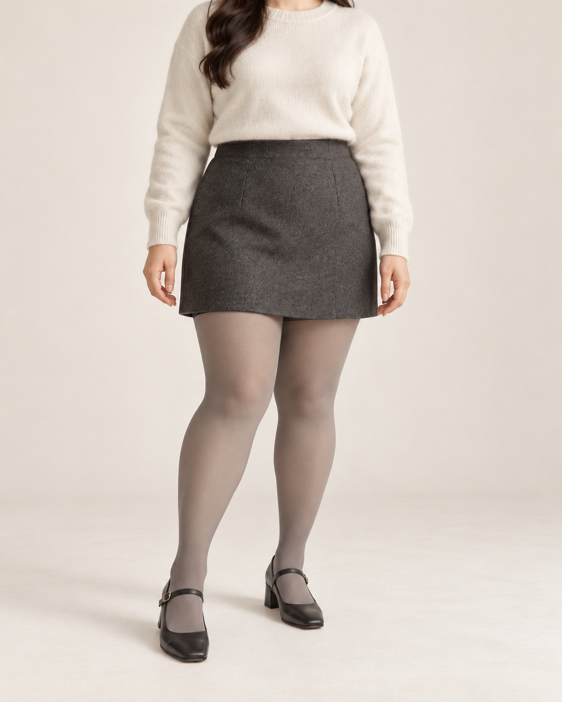 Smoke tights on a fuller-figure adult model in an ivory sweater and skirt, front studio view; Plus styling illustration